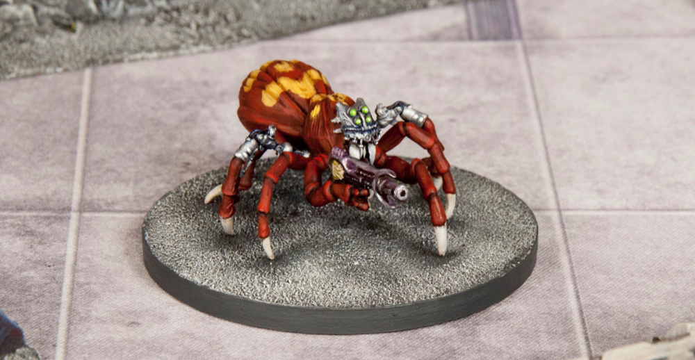 A science fiction Miniature Spider with a gun and cybernetic parts.