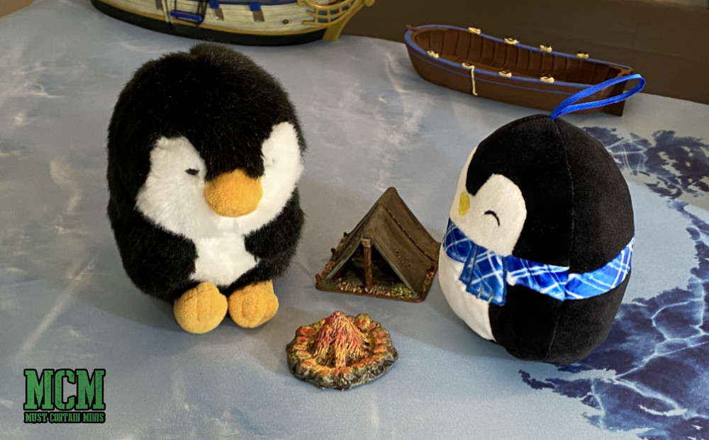 Stuffie Penguins Camp around a Fire Pit and Tent