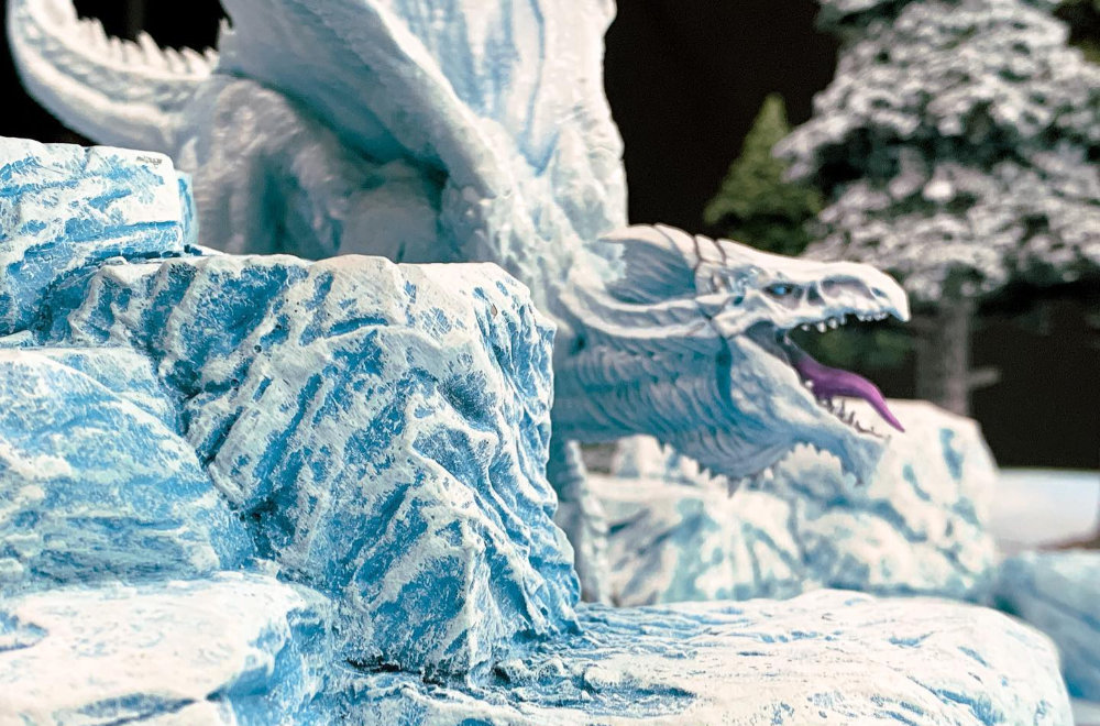 An Ice Dragon on a table with fantastic terrain for role playing games and miniature wargames.