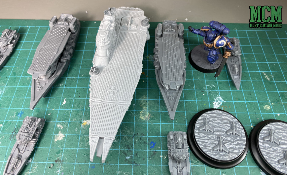 Scale comparison of the Tempelhof Battlefleet vs a Warhammer 40,000 Primarus Space Marine. The ships are so big! Compare the size of the base to the ships.