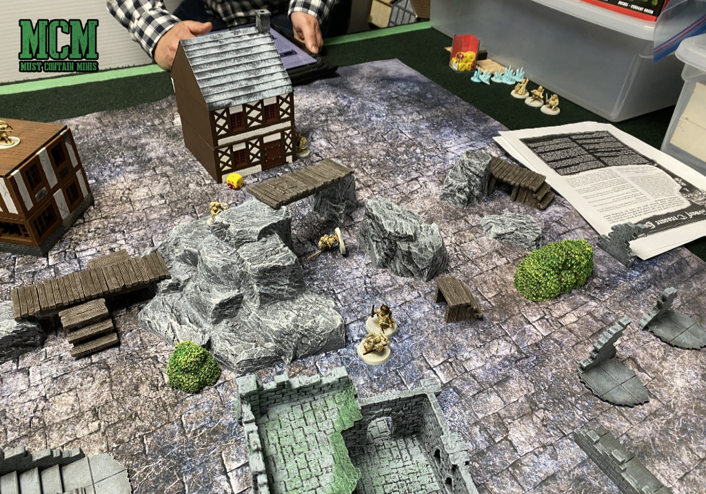 A great gaming table with a cigar box battle mat and terrain by XOLK and Monster Fight Club